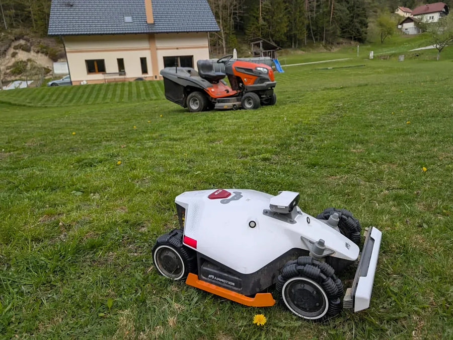 MAMMOTION robotic mower crossing a landscaped lawn